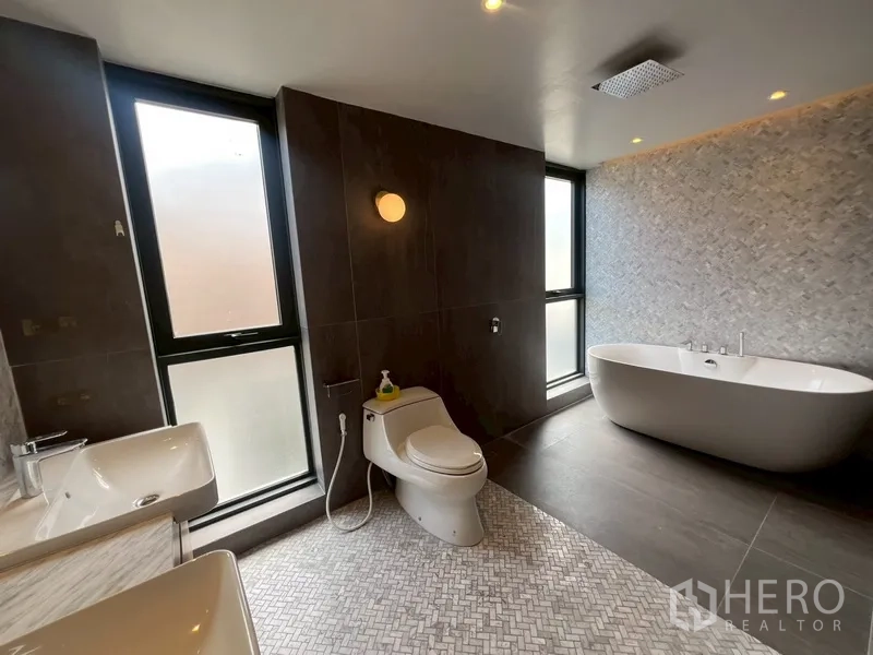 Home Office for rent or sale in Phra Khanong, Bangkok - Modern bathroom with freestanding tub, two basins and rain shower.
