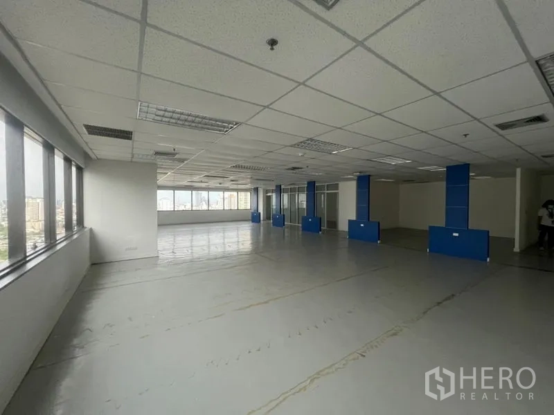 Office Space for rent - Spacious office floor with panoramic windows and blue column features.