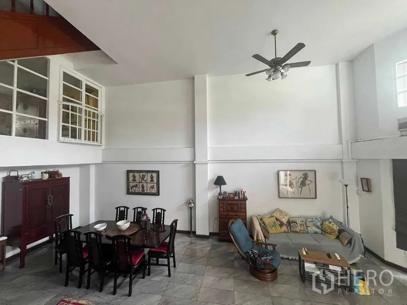 Home Office for rent in Bang Rak, Bangkok - Open-plan dining and living room featuring a double-height ceiling and ceiling fan.