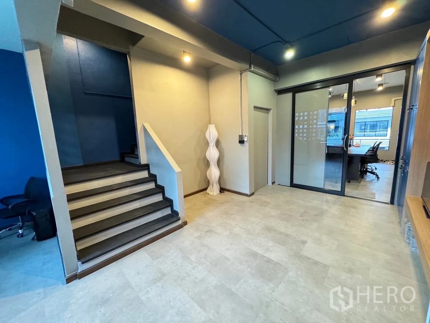 Home Office for rent in Watthana, Bangkok - Entry lobby with staircase and glass doors leading to the meeting room.