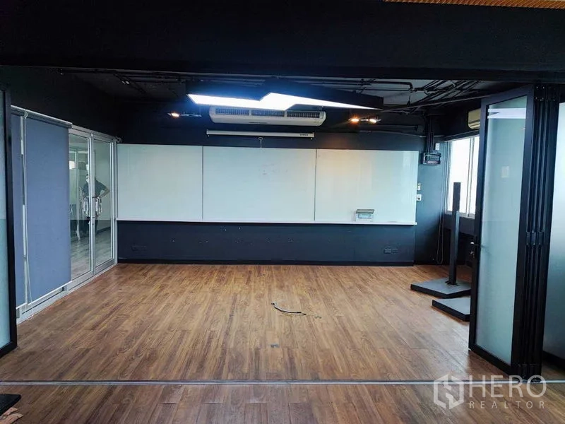 Office Space for rent in Watthana, Bangkok - Presentation-ready room with extra-large whiteboard, LED lighting, and timber flooring.