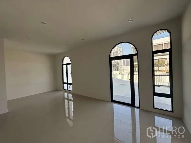 Factory for sale in Lam Luk Ka, Pathum Thani - Ground-floor office area with arched glass doors opening to the forecourt.