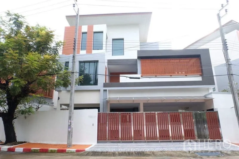 Detached House for sale in Bang Phli, Samut Prakan - Modern three-storey detached house exterior with gated fence and carport.