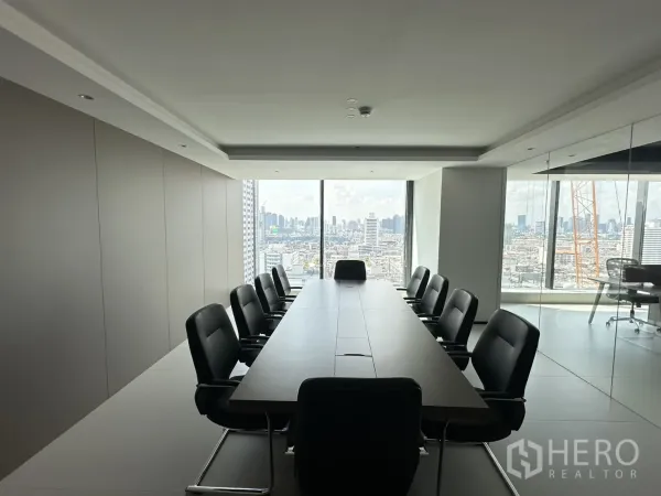 Office Space for rent in Din Daeng, Bangkok - Conference room with a long boardroom table and black chairs facing a city view.
