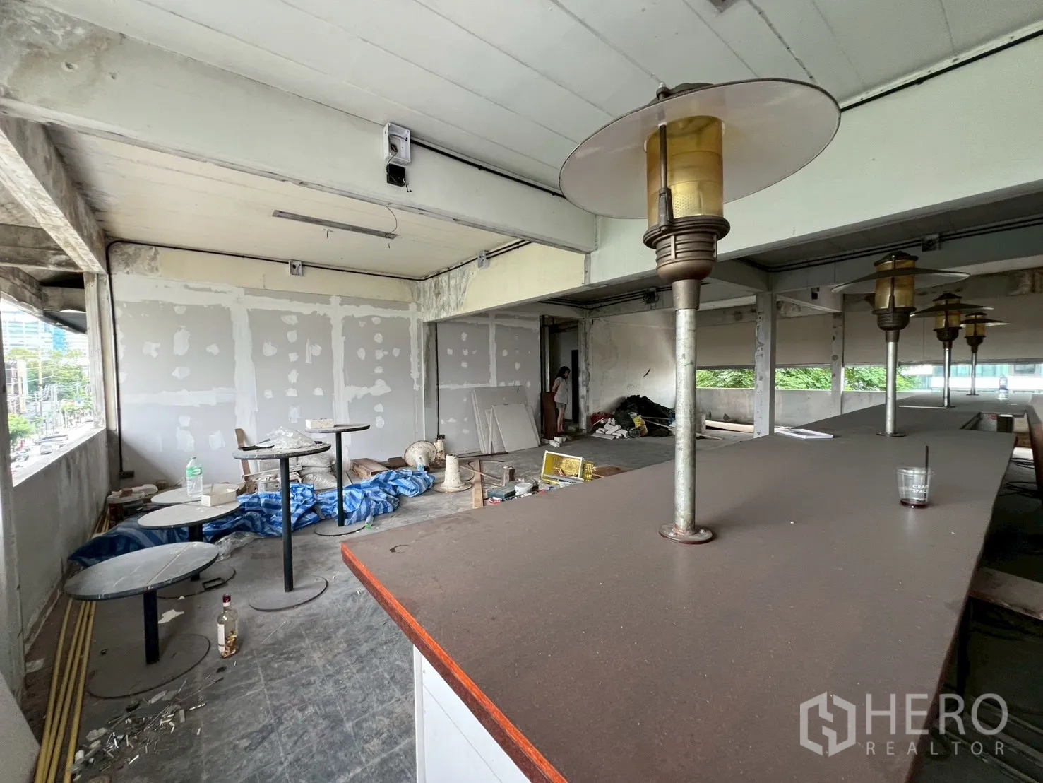 Retail Space for rent in Watthana, Bangkok - Bar counter with lamps and small round tables beside bright windows overlooking the street.