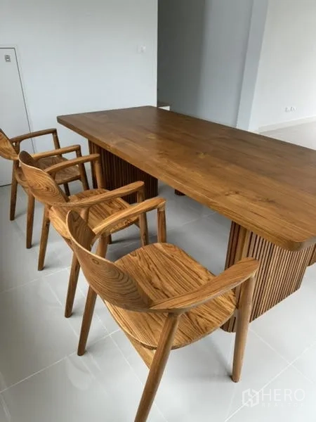 Townhouse for rent in Bang Phli, Samut Prakan - Close-up of matching wooden dining table and armchairs.