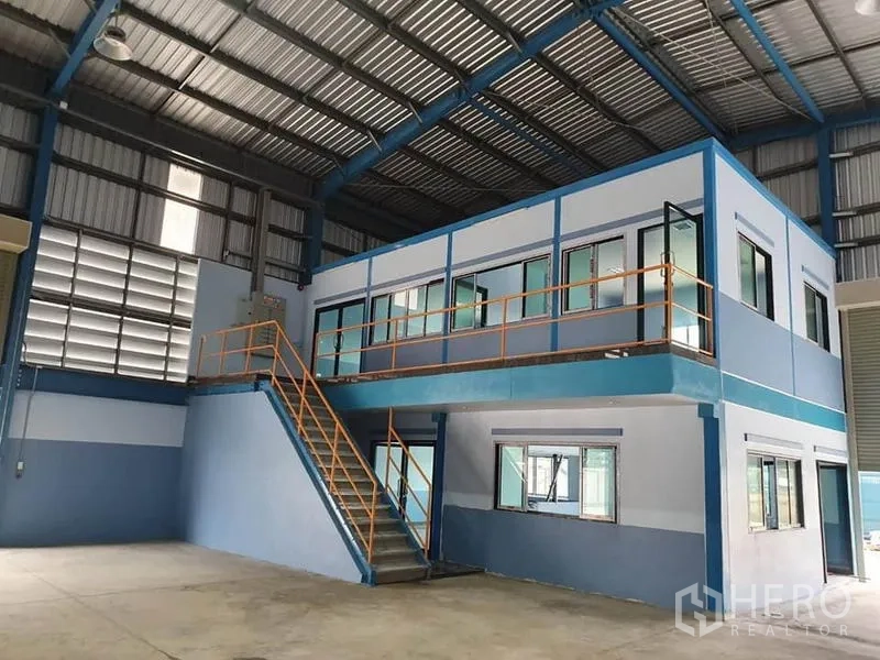 Factory for rent or sale in Phanat Nikhom, Chon Buri - Two-storey internal office block with staircase overlooking the factory floor.