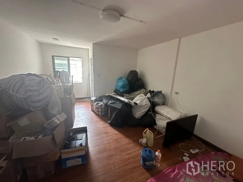 Home Office for rent in Sathon, Bangkok - Secondary bedroom or storage room with window and wood flooring.
