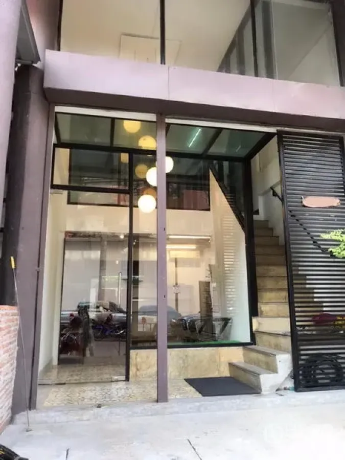 Retail Space for rent in Khlong Toei, Bangkok - Modern glass storefront with double-height façade, entry steps and adjacent staircase.