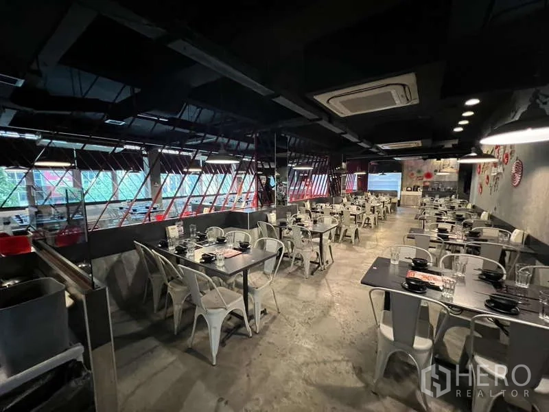 Shophouse for rent or sale in Khlong Toei, Bangkok - Restaurant seating area with murals, red chairs and display chiller.