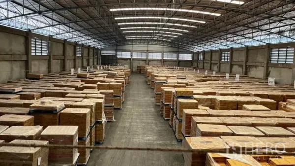 Factory for rent or sale in Pathum Thani - Long central aisle with stacked pallets inside a spacious warehouse.
