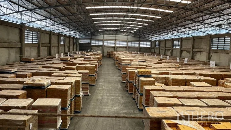 Factory for rent or sale in Pathum Thani - Long central aisle with stacked pallets inside a spacious warehouse.