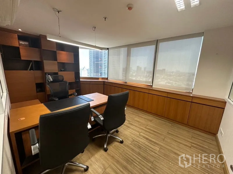Office Space for rent or sale - Private corner office with large windows, custom shelving and two chairs.