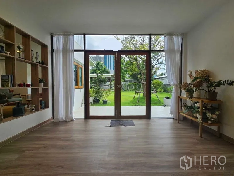 Home Office for rent - Room with glass doors opening to the garden, feature shelving and decorative plants.