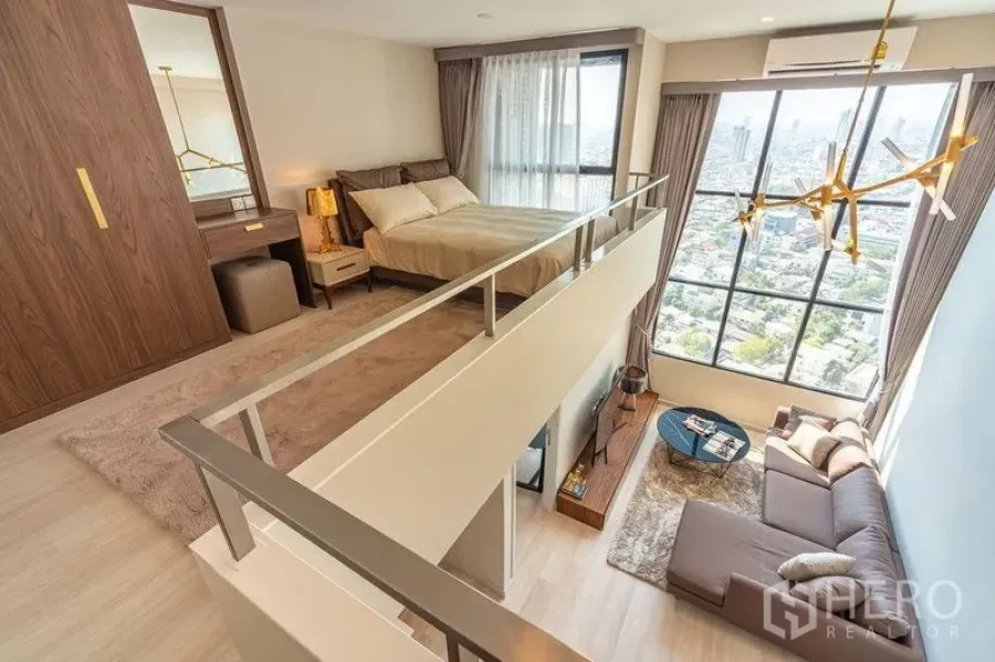 Condominium for rent in Sathon, Bangkok - Loft bedroom and catwalk overlooking the double-height living room and skyline.