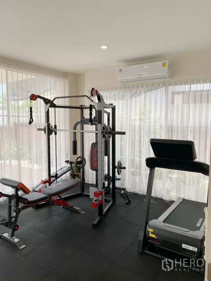 Detached House for sale in Sai Mai, Bangkok - Glass-wrapped fitness room with multi-gym station and treadmill.