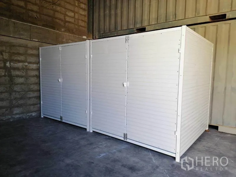 Factory for rent in Bang Phli, Samut Prakan - White modular storage room inside the factory with concrete floor and brick wall.
