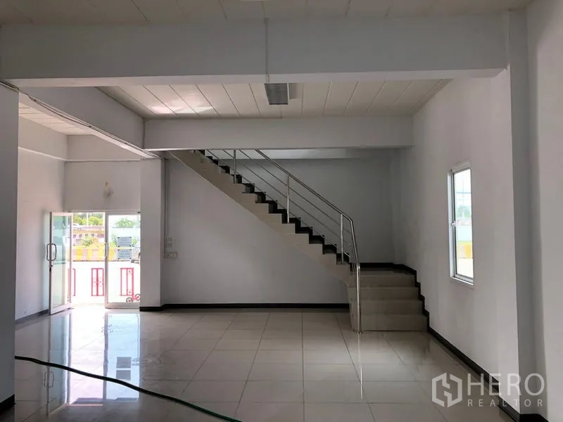Warehouse for rent in Phra Nakhon Si Ayutthaya - Ground-floor office lobby with tiled flooring and a metal staircase.