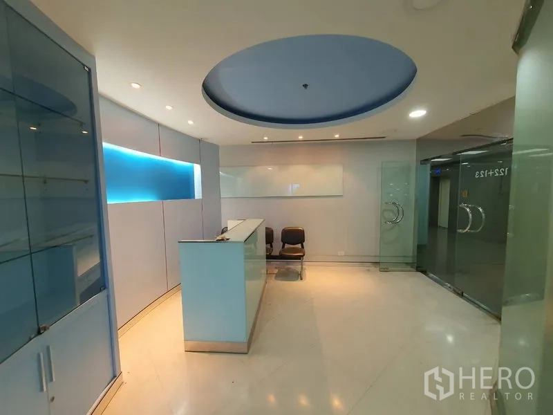 Office Space for rent in Watthana, Bangkok - Modern reception lobby with curved ceiling, glass doors and a front desk.