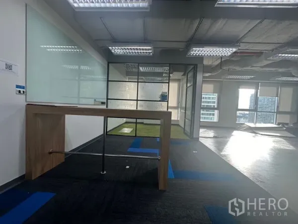 Office Space for rent in Bang Rak, Bangkok - High table beside a glass-walled meeting room with floor-to-ceiling windows and city views.