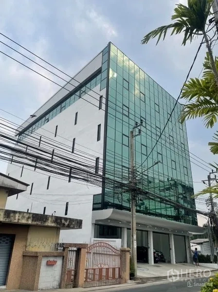 Home Office for rent or sale in Wang Thonglang, Bangkok - Side exterior view with covered parking and street frontage.