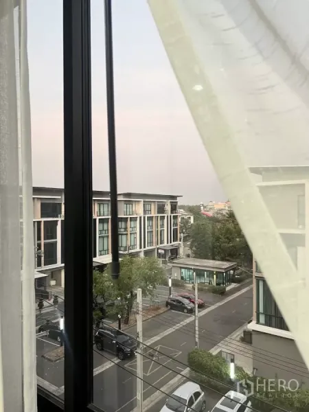 Home Office for rent in Lat Phrao, Bangkok - View from an upper-floor window across the gated community street and home office blocks.