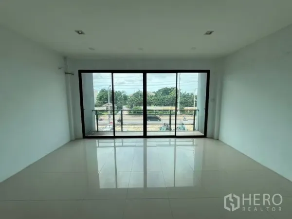 Warehouse for rent in Bang Phli, Samut Prakan - Bright office room with floor-to-ceiling sliding glass doors opening to a small balcony and street view.