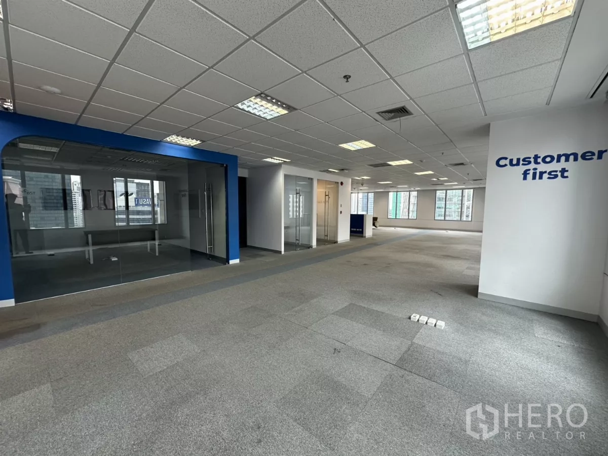 Office Space for rent in Watthana, Bangkok - Open workspace with glass-walled meeting rooms and city views through wide windows.