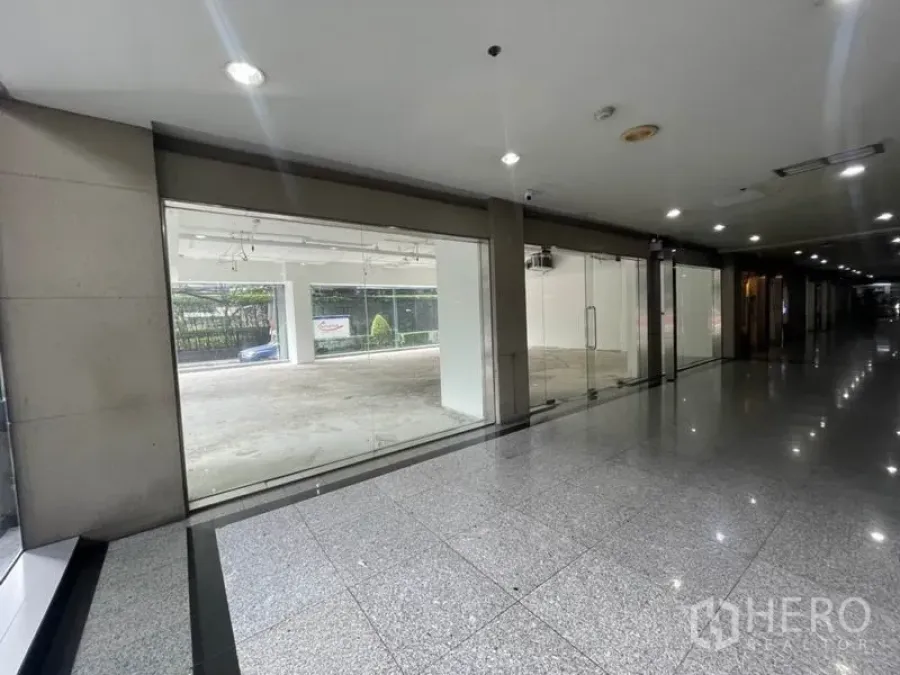 Retail Space for rent in Watthana, Bangkok - Ground-floor retail unit with full-height glass shopfront facing a polished lobby corridor.