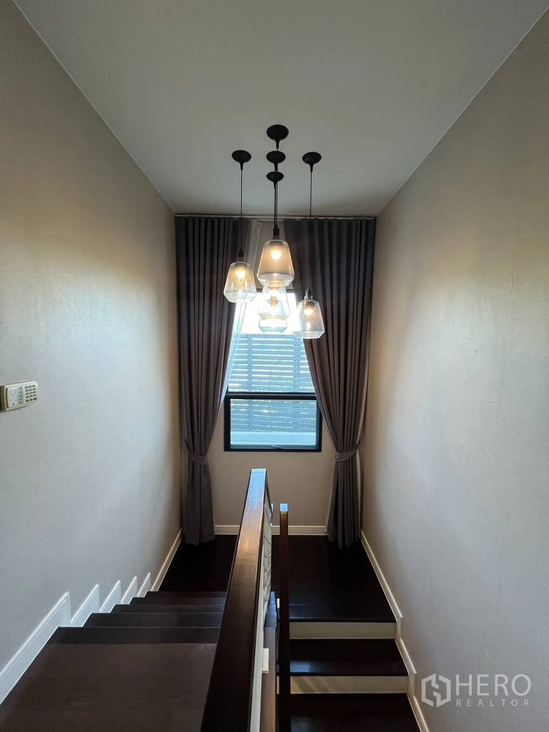 Detached House for rent or sale in Bang Kapi, Bangkok - Staircase landing with modern pendant lights, window and full drapery.