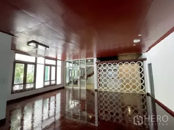 Home Office for rent in Watthana, Bangkok - Open-plan interior with glossy wooden floors, large windows and a glass partition wall.