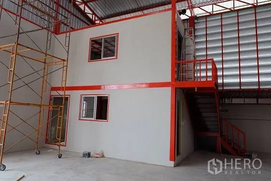 Warehouse for rent in Bang Phli, Samut Prakan - Internal office unit with windows beside an upper platform and stairs.