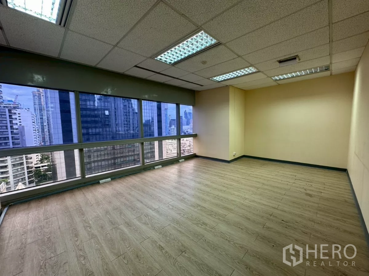 Office Space for rent in Watthana, Bangkok - Spacious office with panoramic windows, wood flooring and skyline view.