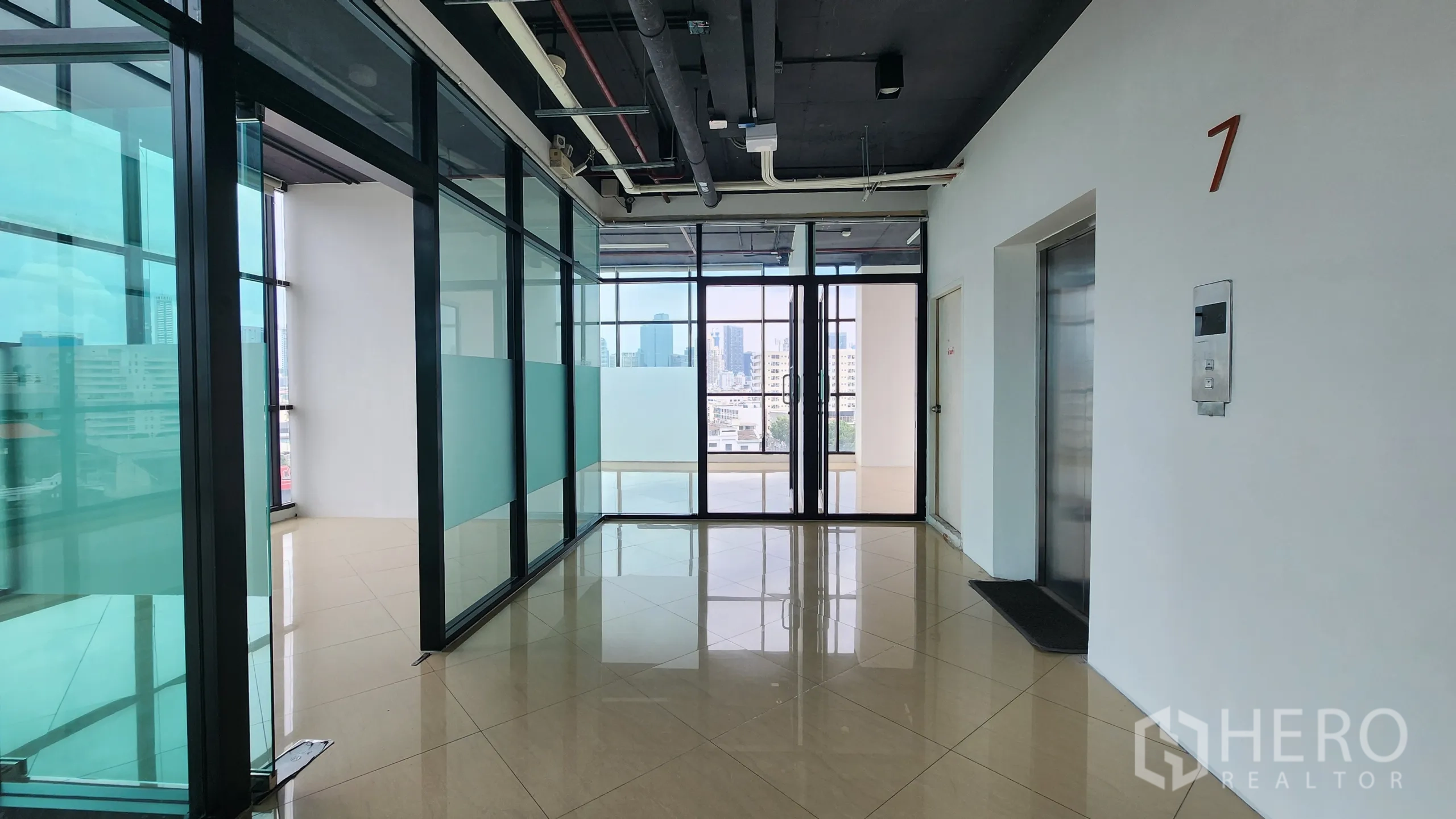 Office Space for rent in Yan Nawa, Bangkok - Elevator lobby leading to glass-walled offices and city-facing windows.