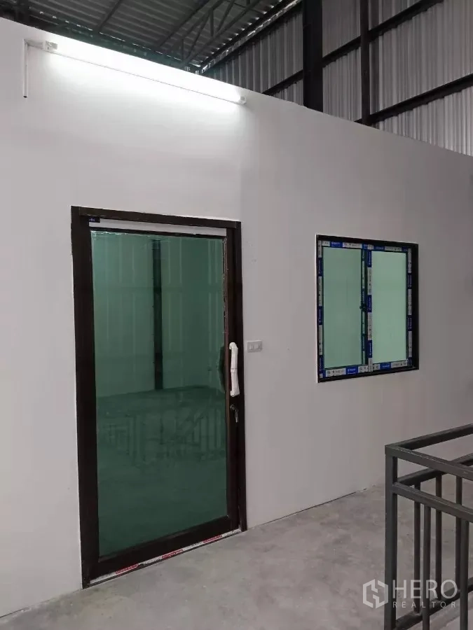 Warehouse for rent in Khlong Toei, Bangkok - Mezzanine office entrance with sliding glass door and window.