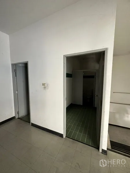Factory for rent in Si Racha, Chon Buri - Staff restroom and utility doors within the factory service area.