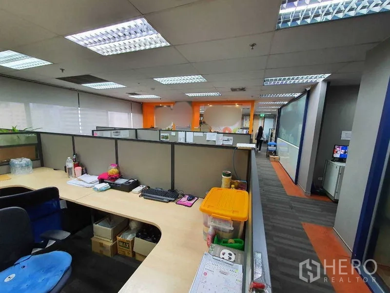 Office Space for rent in Watthana, Bangkok - Corner workstation bench overlooking the open-plan office and orange accent wall.