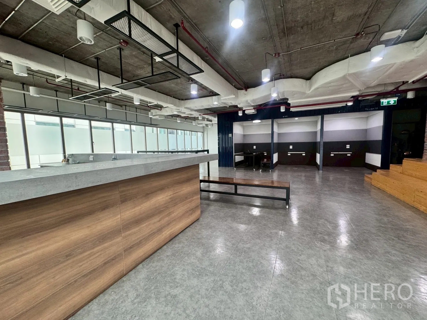 Office Space for rent in Watthana, Bangkok - Pantry bar counter with industrial light fixtures and bench seating.