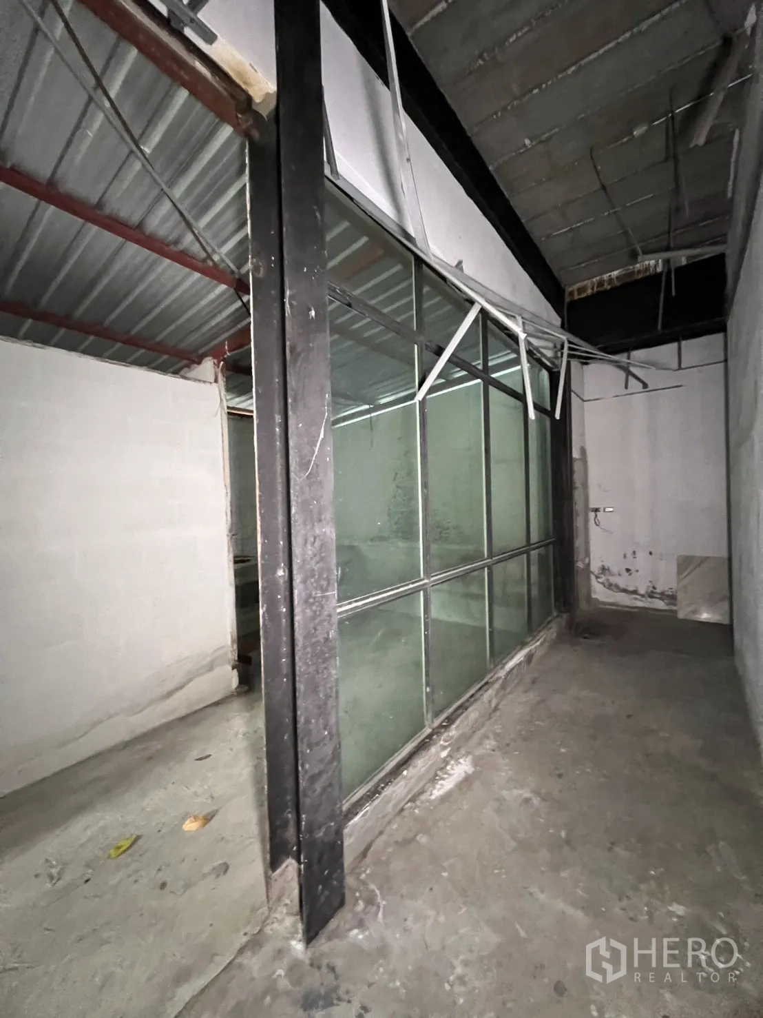 Retail Space for rent in Watthana, Bangkok - Glass-front foyer with a small display counter and colorful window graphic.