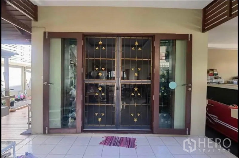 Detached House for sale in Bang Yai, Nonthaburi - Front entrance with sliding glass doors and decorative security grilles.