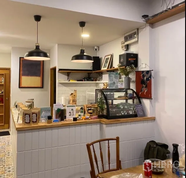 店屋 出租在Watthana, Bangkok - 带玻璃展示柜的吧台，白色地铁砖墙和黑色吊灯。
