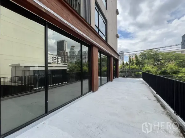Retail Space for rent in Watthana, Bangkok - Outdoor terrace fronting floor-to-ceiling glass with city skyline views.