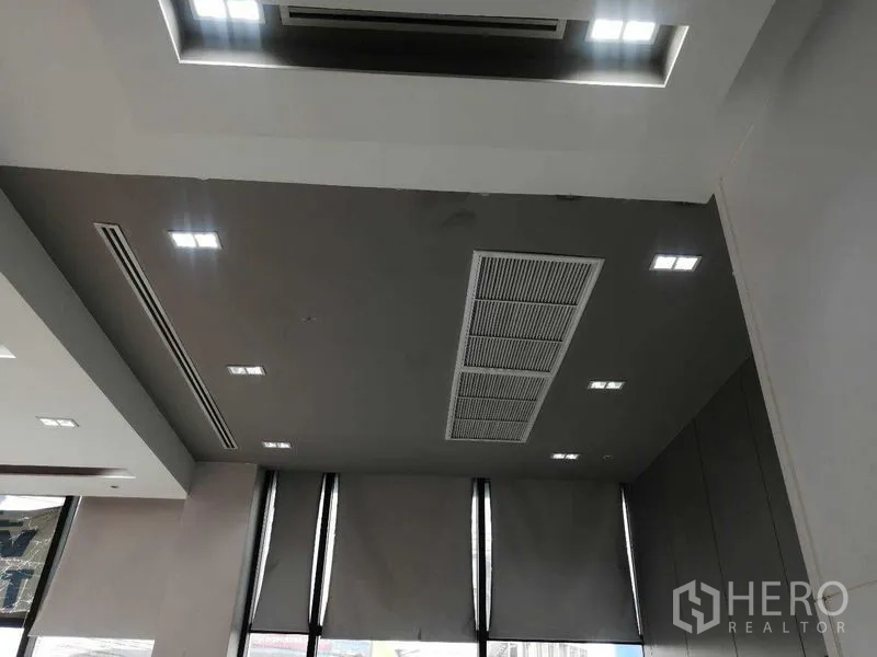 Office Space for rent in Pathum Wan, Bangkok - Office ceiling with recessed lighting, ducted air-conditioning, and tall windows with blinds.