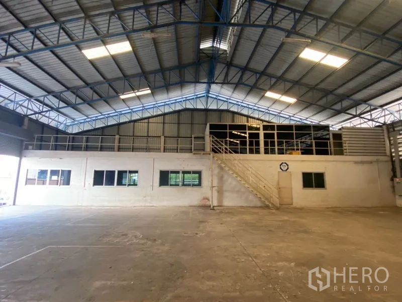 Factory for rent in Lat Lum Kaeo, Pathum Thani - Mezzanine offices with windows and a metal staircase overlooking the floor.