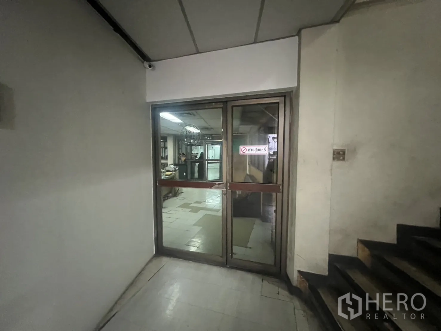 Shophouse for rent - Entrance corridor with sliding glass doors leading into office zone.