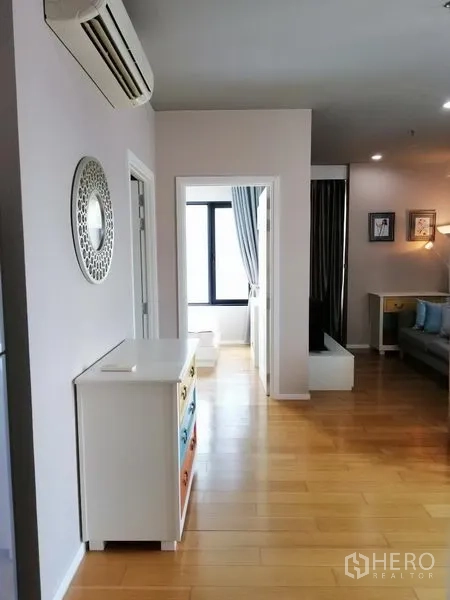 Condominium for rent in Watthana, Bangkok - Hallway linking bedrooms and living area with light wood floors