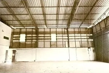 Warehouse for rent in Lat Phrao, Bangkok - Open-plan warehouse floor with tall walls, ventilation panels and a roller shutter door.