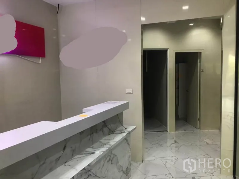 Retail Space for rent in Watthana, Bangkok - Front counter area with sliding doors to back rooms and a restroom inside the retail space.