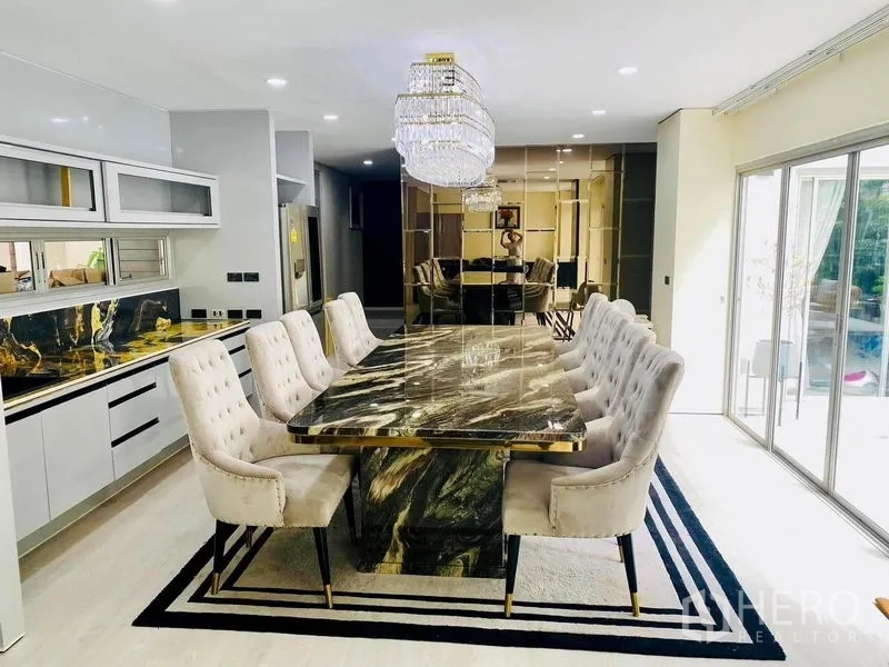Detached House for rent in Suan Luang, Bangkok - Elegant dining room featuring a marble table, crystal chandeliers and garden outlook.