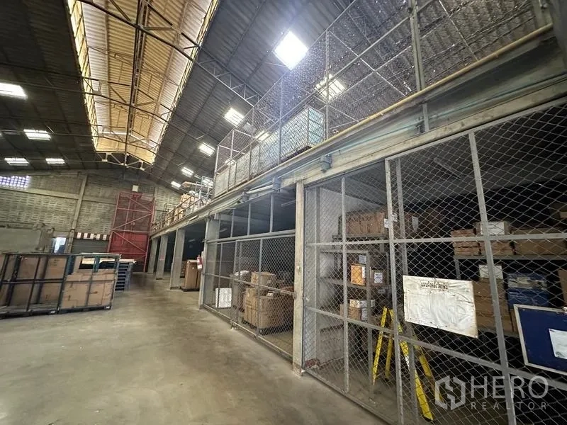 Factory for rent in Lam Luk Ka, Pathum Thani - Mezzanine level with chain-link secure storage cages and shelving.